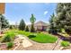 Serene backyard featuring mature trees, manicured lawn, and inviting patio area for outdoor enjoyment at 23644 E Phillips Pl, Aurora, CO 80016