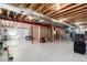 Unfinished basement showing exposed ceiling beams and the beginning stages of interior wall construction at 23644 E Phillips Pl, Aurora, CO 80016
