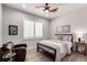 This bedroom features hardwood floors, a ceiling fan and an oversized window with plantation shutters at 23644 E Phillips Pl, Aurora, CO 80016
