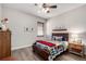 This bedroom features hardwood floors, a ceiling fan and a vintage-style dresser at 23644 E Phillips Pl, Aurora, CO 80016