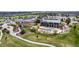 Aerial view of community clubhouse with a pool, outdoor seating, and a well-manicured lawn at 23644 E Phillips Pl, Aurora, CO 80016