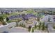 Aerial view of the community clubhouse featuring a circular driveway and ample parking at 23644 E Phillips Pl, Aurora, CO 80016