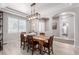 Bright dining room with a wooden table, seating for six, a modern light fixture, and natural light at 23644 E Phillips Pl, Aurora, CO 80016