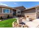 Charming home featuring a lush landscaped yard, brick accents, and a welcoming entryway at 23644 E Phillips Pl, Aurora, CO 80016