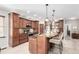 Well-equipped kitchen with an island, stainless appliances, wood cabinets, and tiled backsplash at 23644 E Phillips Pl, Aurora, CO 80016