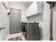 This laundry room features storage cabinets and washer and dryer set at 23644 E Phillips Pl, Aurora, CO 80016