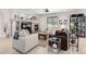 Bright living room features a stone fireplace, ceiling fan, and adjacent display shelving at 23644 E Phillips Pl, Aurora, CO 80016