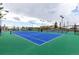 Community tennis courts featuring a blue playing surface and green perimeter at 23644 E Phillips Pl, Aurora, CO 80016