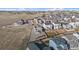 Aerial view showcases this home's backyard, fencing, and location within a vast community at 1110 Black Saddle St, Elizabeth, CO 80107