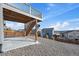 View of the backyard with deck stairs, patio, and perimeter fence on a sunny day at 1110 Black Saddle St, Elizabeth, CO 80107