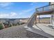 Backyard features a concrete patio and a staircase leading to an upper deck overlooking a field at 1110 Black Saddle St, Elizabeth, CO 80107