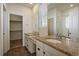 Well-lit bathroom featuring dual sinks, granite countertops, and a glass-enclosed shower at 1110 Black Saddle St, Elizabeth, CO 80107