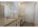 A well-lit bathroom featuring dual sinks with granite countertops and a glass-enclosed shower at 1110 Black Saddle St, Elizabeth, CO 80107