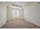 A light and airy bedroom with neutral walls, plush carpeting, and a large window at 1110 Black Saddle St, Elizabeth, CO 80107