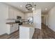 Well-lit kitchen featuring granite countertops, an island, stainless steel appliances, and modern fixtures at 1110 Black Saddle St, Elizabeth, CO 80107