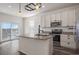 Bright kitchen featuring an island, stainless steel appliances, granite countertops, and hardwood floors at 1110 Black Saddle St, Elizabeth, CO 80107