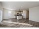 Open concept kitchen and living room area with hardwood floors and modern appliances at 1110 Black Saddle St, Elizabeth, CO 80107