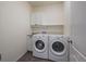 Convenient laundry room featuring a washer, dryer, and storage space at 1110 Black Saddle St, Elizabeth, CO 80107