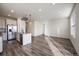 Bright and open-concept living room and kitchen with an island and stainless steel appliances at 1110 Black Saddle St, Elizabeth, CO 80107