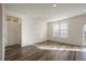 Spacious living room with a large window offering plenty of natural light and hardwood floors at 1110 Black Saddle St, Elizabeth, CO 80107