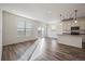 Bright living room with wood floors, recessed lighting, and sliding glass doors to the backyard at 1110 Black Saddle St, Elizabeth, CO 80107