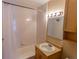 Clean bathroom with a shower-tub combo, vanity and neutral finishes at 2500 S York St # 213, Denver, CO 80210