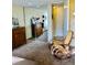 Bedroom featuring closet with mirrored doors, rocking chair, and chest of drawers at 2500 S York St # 213, Denver, CO 80210