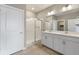 Bathroom with double sink vanity, shower, and tile flooring at 13497 Valentia St, Thornton, CO 80602