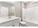 Bathroom featuring a shower-tub combo, white vanity, and light walls at 13497 Valentia St, Thornton, CO 80602
