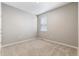 Cozy bedroom featuring a window and neutral walls at 13497 Valentia St, Thornton, CO 80602