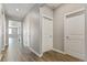 Hallway with wood flooring and white trim leading to various rooms at 13497 Valentia St, Thornton, CO 80602