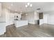 Kitchen with white cabinets, stainless steel appliances and wood flooring at 13497 Valentia St, Thornton, CO 80602