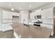 Open kitchen with large island, stainless steel appliances, and tile backsplash at 13497 Valentia St, Thornton, CO 80602