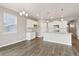 Spacious kitchen with white cabinets, modern lighting, and stainless steel appliances at 13497 Valentia St, Thornton, CO 80602