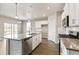 Open concept kitchen featuring modern appliances and island with bar seating at 13497 Valentia St, Thornton, CO 80602