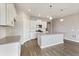 Modern kitchen features an island, stainless steel appliances, and white cabinetry at 13497 Valentia St, Thornton, CO 80602