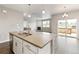 Kitchen island with stainless steel sink, dishwasher, and modern countertops at 13497 Valentia St, Thornton, CO 80602