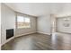 Bright living room with fireplace, wood flooring and sliding glass doors at 13497 Valentia St, Thornton, CO 80602
