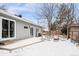 Cozy backyard with a deck, outdoor seating, and snow-covered ground at 6240 W 24Th Ave, Edgewater, CO 80214