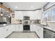 Beautiful kitchen with stainless steel appliances, plenty of counter space, and a seamless flow into the living area at 6240 W 24Th Ave, Edgewater, CO 80214