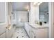 Elegant bathroom with double vanity, marble countertops, and classic black and white tile flooring at 1900 E Girard Pl # 901, Englewood, CO 80113