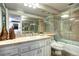 Well-lit bathroom featuring a glass-enclosed shower, white vanity, and tiled backsplash at 1900 E Girard Pl # 901, Englewood, CO 80113