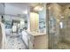 Bathroom with marble countertops, double vanity, shower, and decorative lighting at 1900 E Girard Pl # 901, Englewood, CO 80113