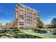 Brick exterior view of the apartment building showing mature landscaping including a small pond at 1900 E Girard Pl # 901, Englewood, CO 80113