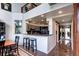 A modern kitchen with sleek countertops and stainless steel appliances open to the dining area at 1900 E Girard Pl # 901, Englewood, CO 80113