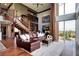Cozy living room with a spiral staircase, floor-to-ceiling windows, and cityscape views at 1900 E Girard Pl # 901, Englewood, CO 80113