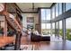 Light filled living room with staircase, leather furniture, and stunning cityscape views at 1900 E Girard Pl # 901, Englewood, CO 80113