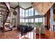 Expansive living room with spiral staircase, chandelier, floor-to-ceiling windows, and dining area at 1900 E Girard Pl # 901, Englewood, CO 80113