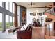 Stylish living room showcasing a fireplace, spiral staircase, and views from large windows at 1900 E Girard Pl # 901, Englewood, CO 80113