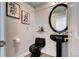 Stylish powder room featuring a black pedestal sink and sleek, modern fixtures at 1900 E Girard Pl # 901, Englewood, CO 80113